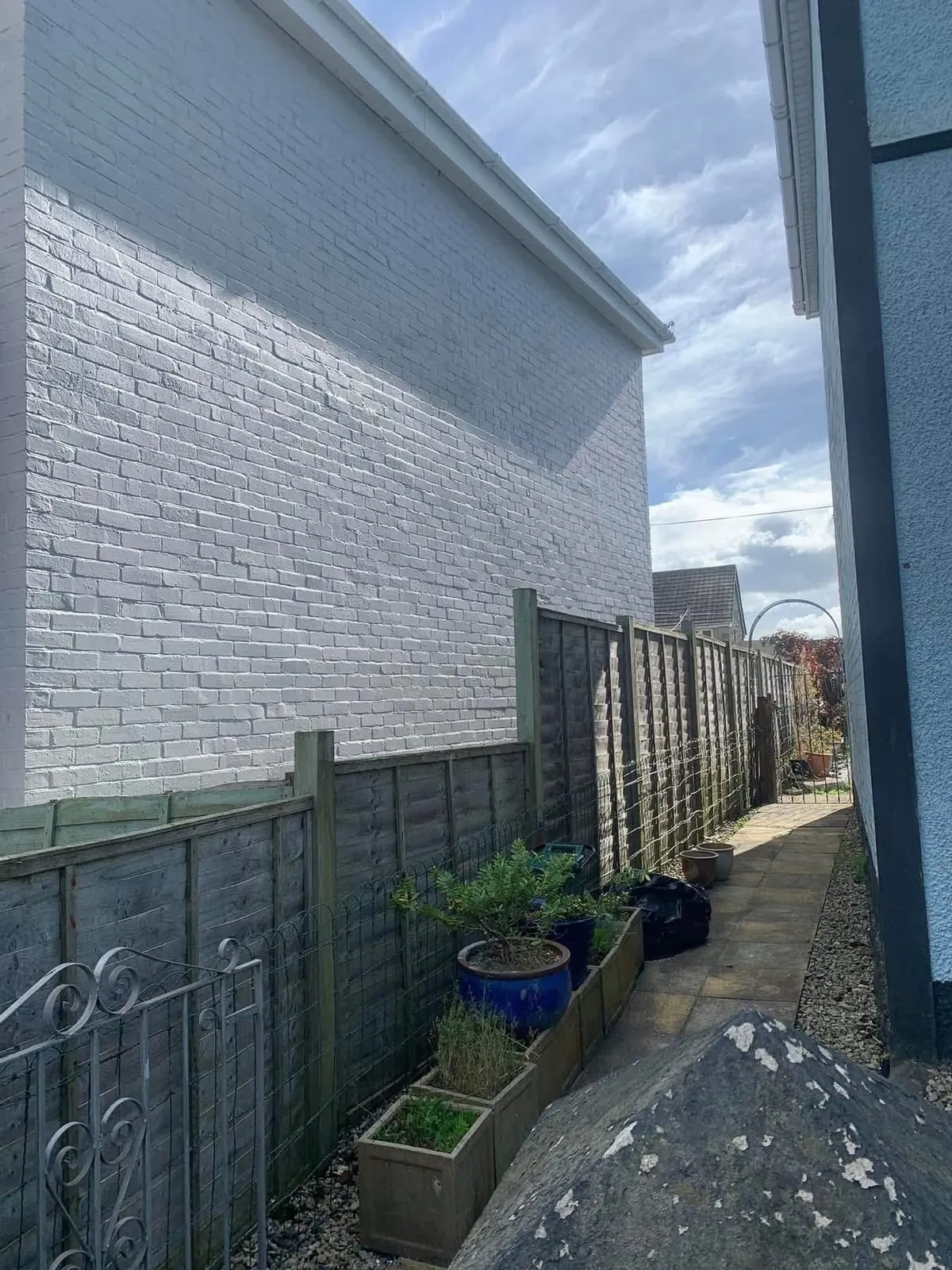 Freshly painted brick wall after preparation and masonry paint in Kingsteignton