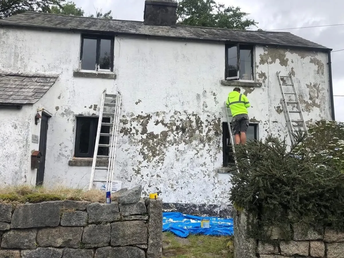 Cottage with blown, flaking render before repair in Kingsteignton